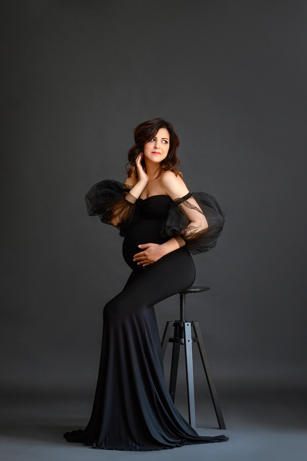 Black tulle sleeves maternity dress, elegant off-shoulder gown for studio photoshoot
