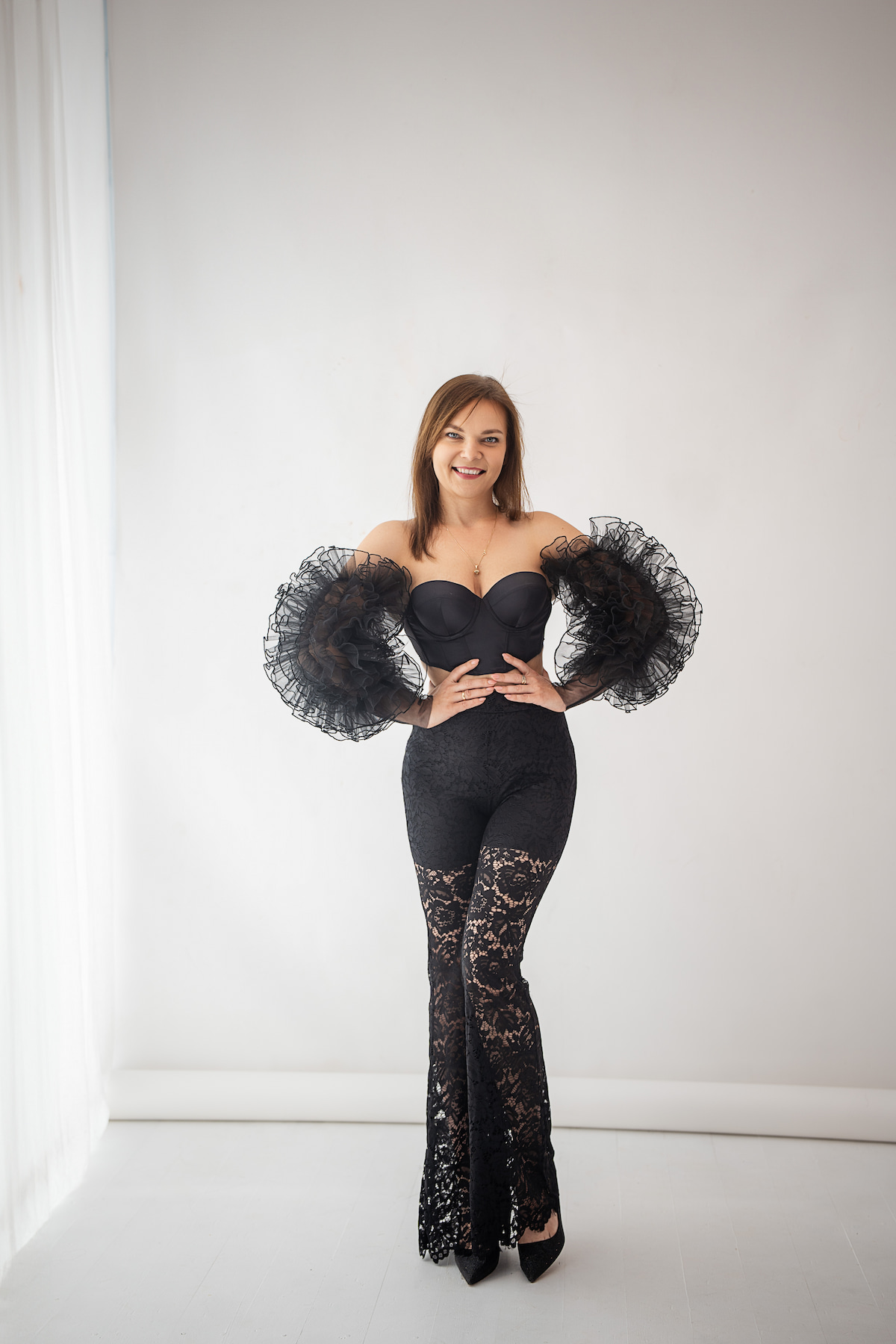 Black sheer ruffle sleeves outfit for photography, dramatic maternity photoshoot styling