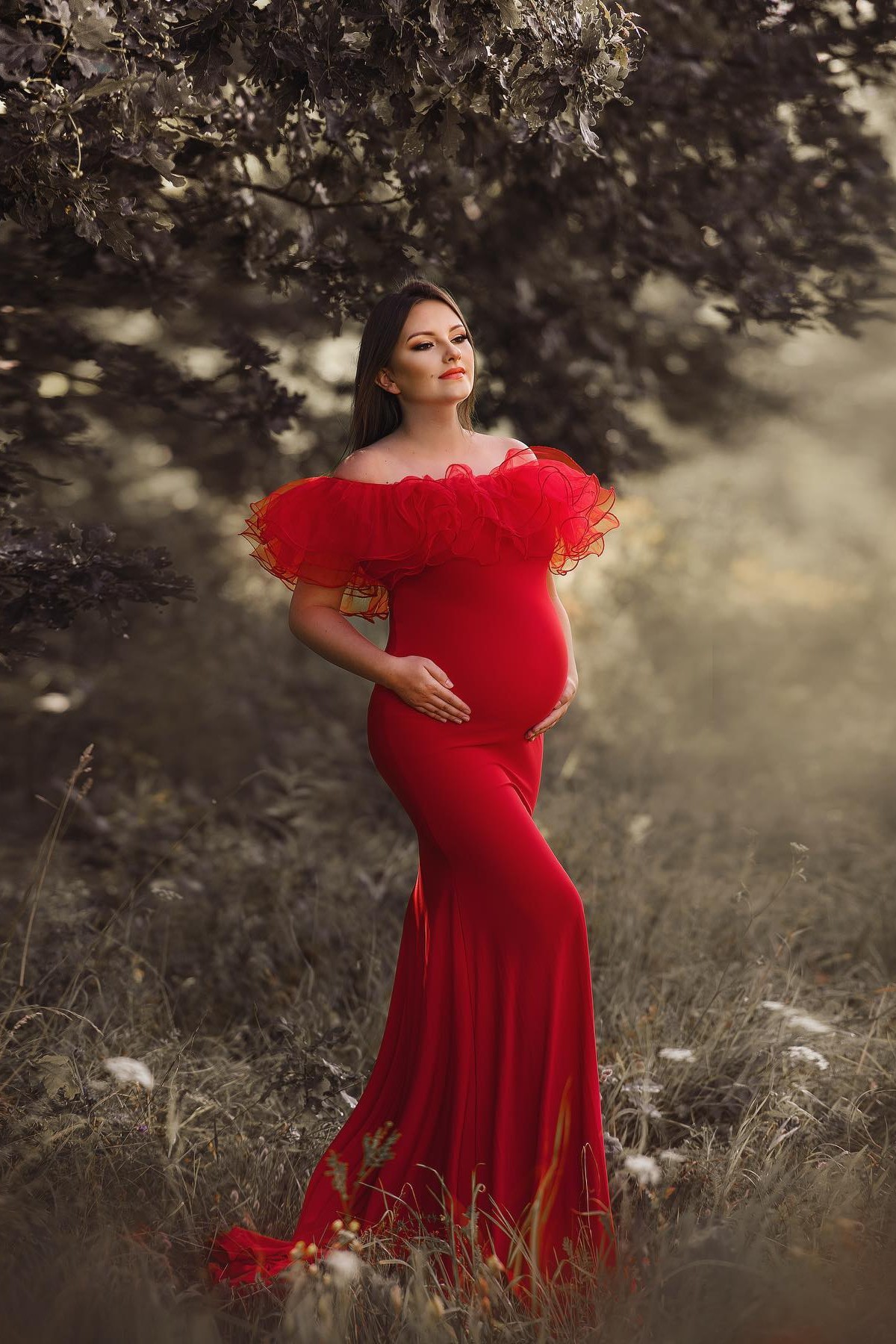 Artistic maternity portrait with voluminous tulle neckline and fitted gown