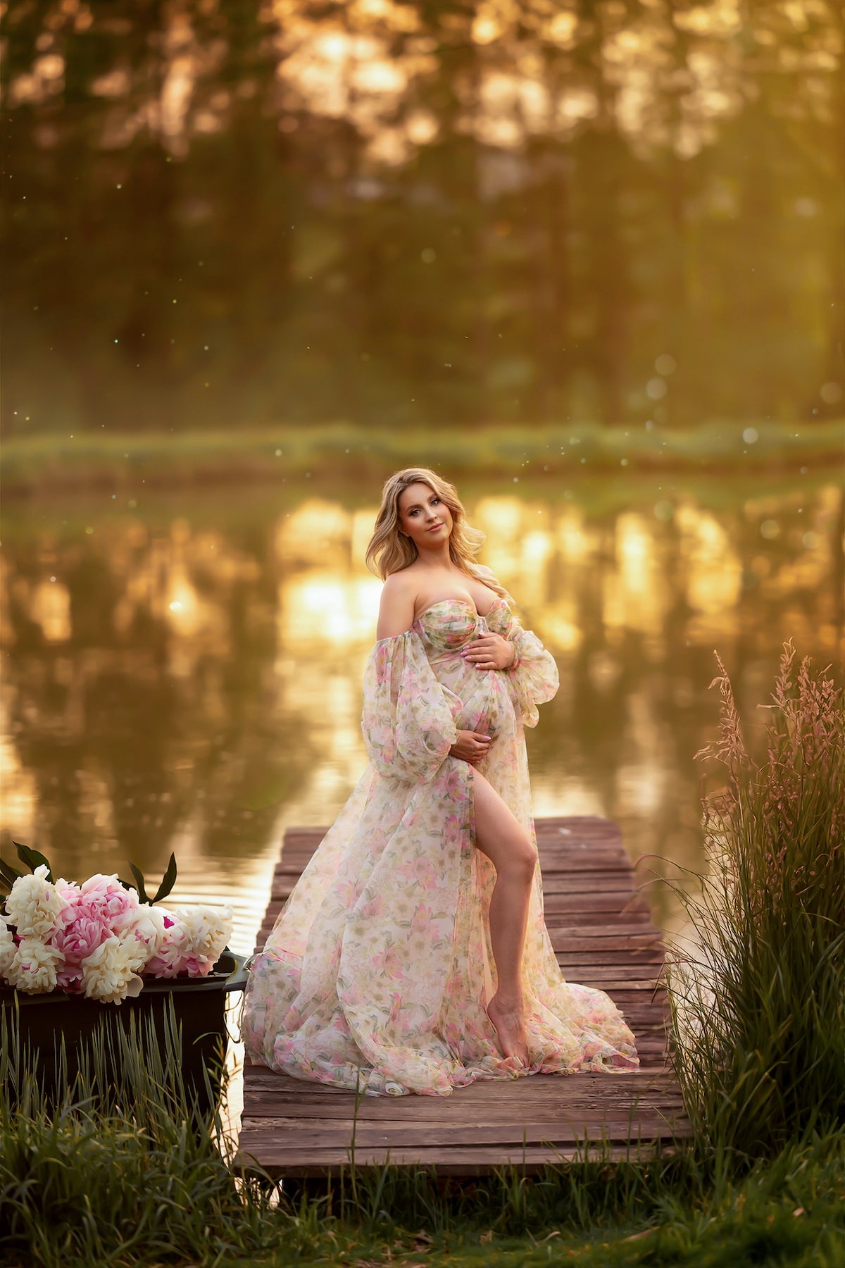Primavera floral maternity dress in soft tulle, captured during golden hour by the lake, perfect for fine art photoshoots.