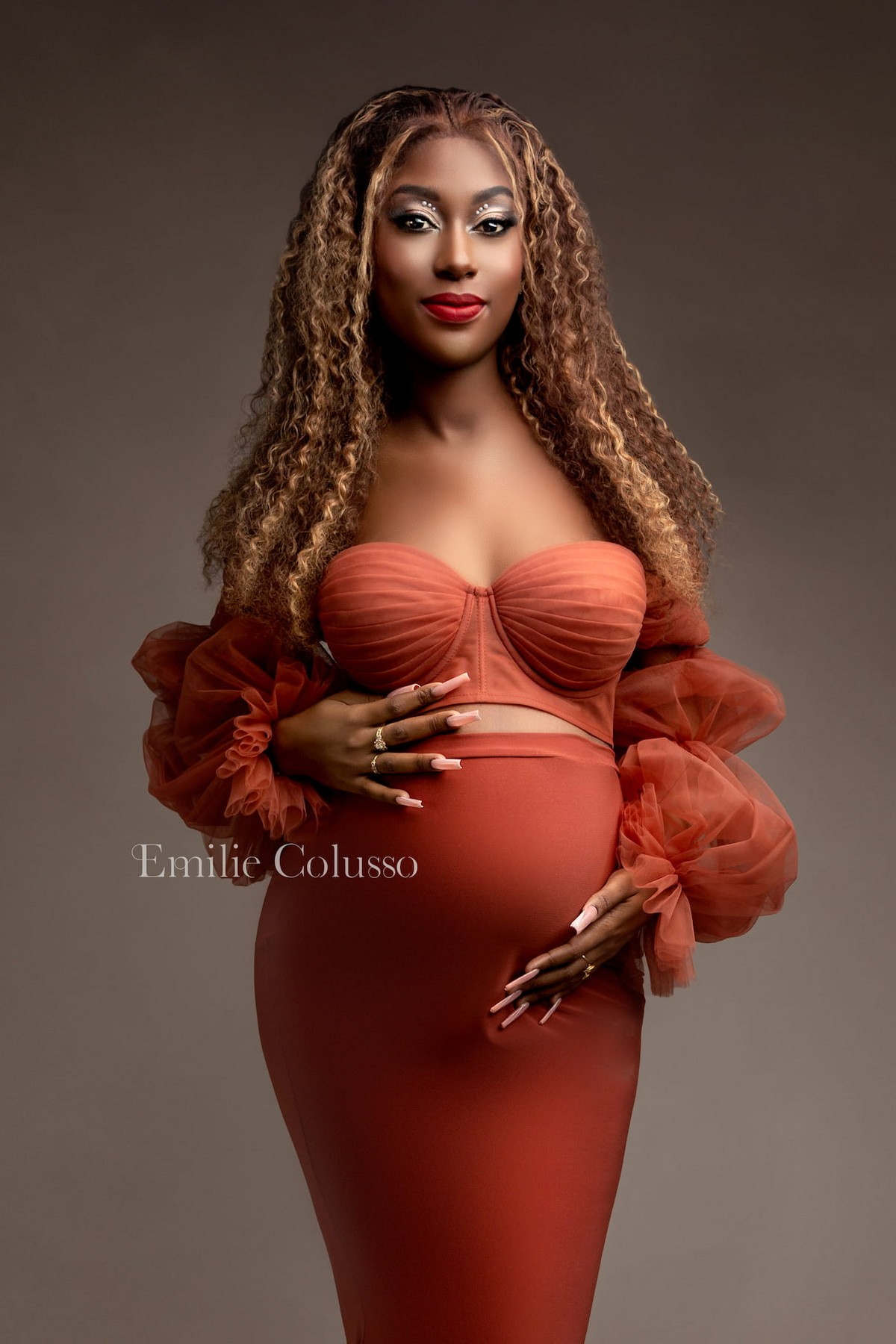 rust maternity gown with puff sleeves and train