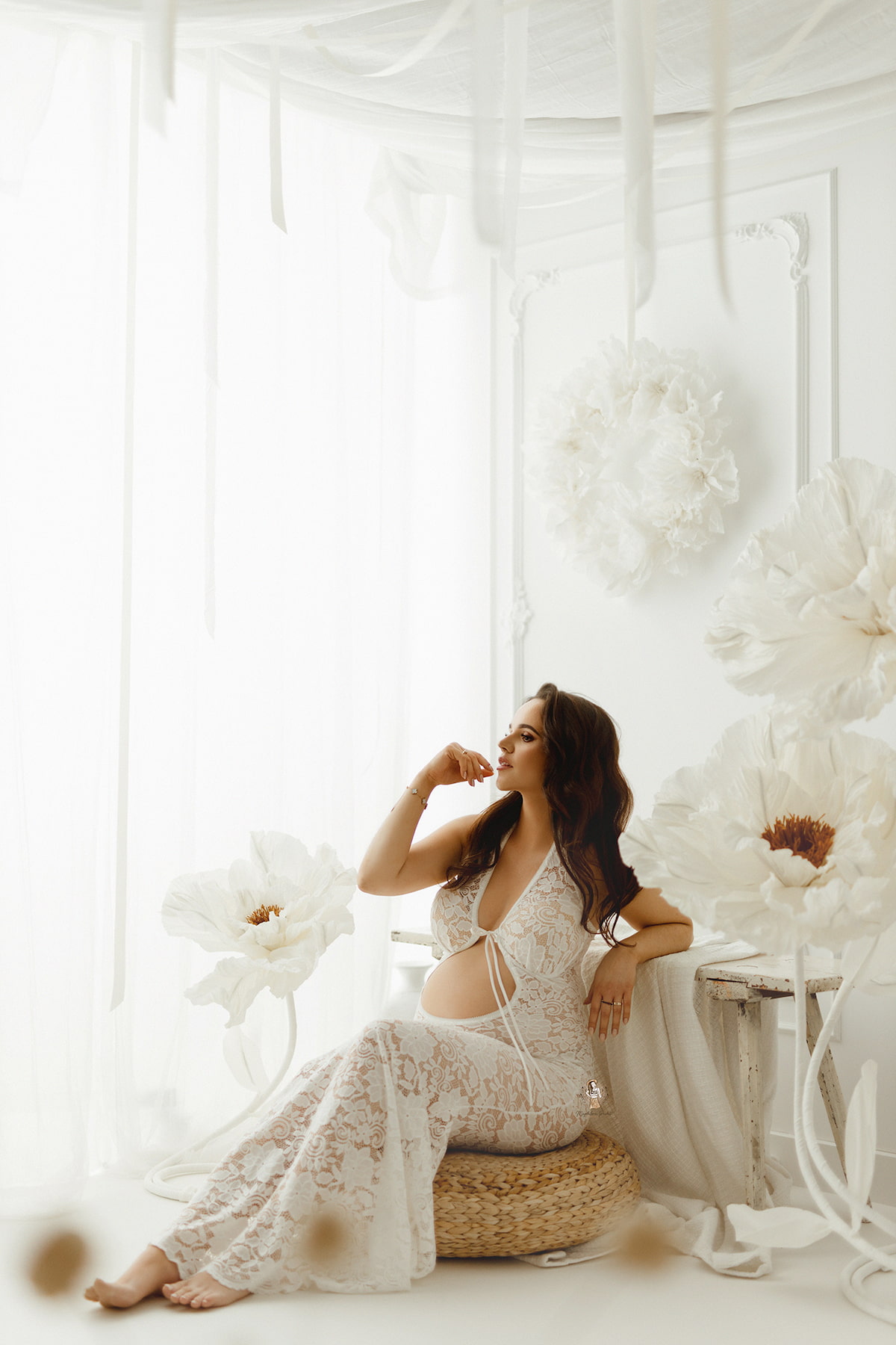 Pregnant woman sitting in the Monroe lace dress